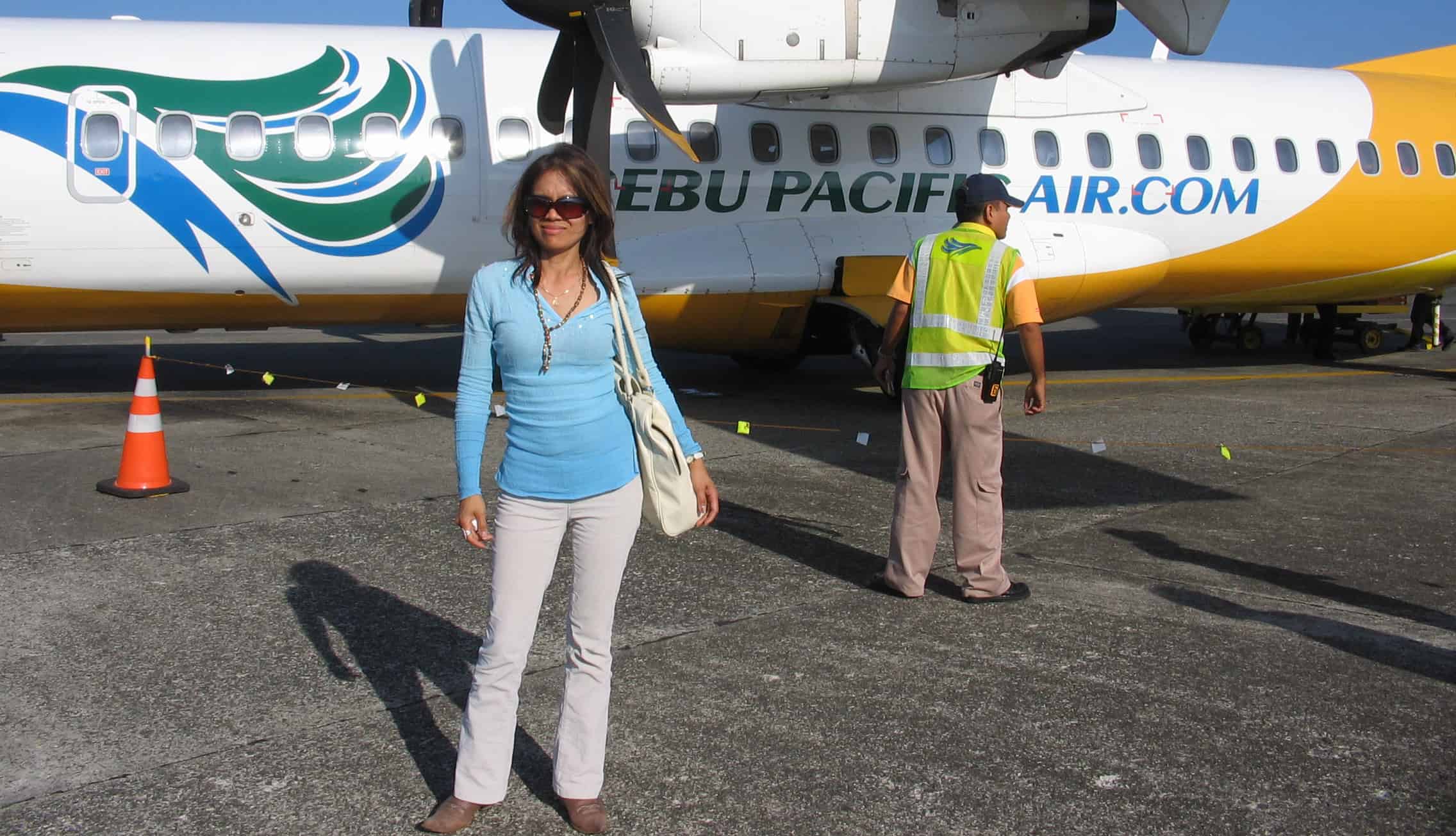 Picture of Helen standing in front of a plane